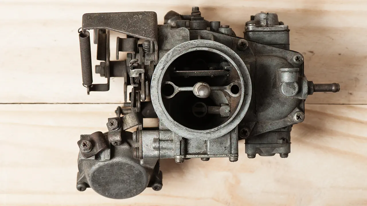 A dirty carburetor from a car.