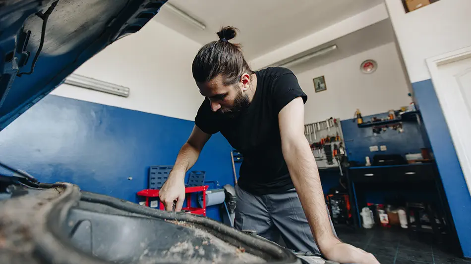Someone working on a car - Troubleshoot Your Vehicle