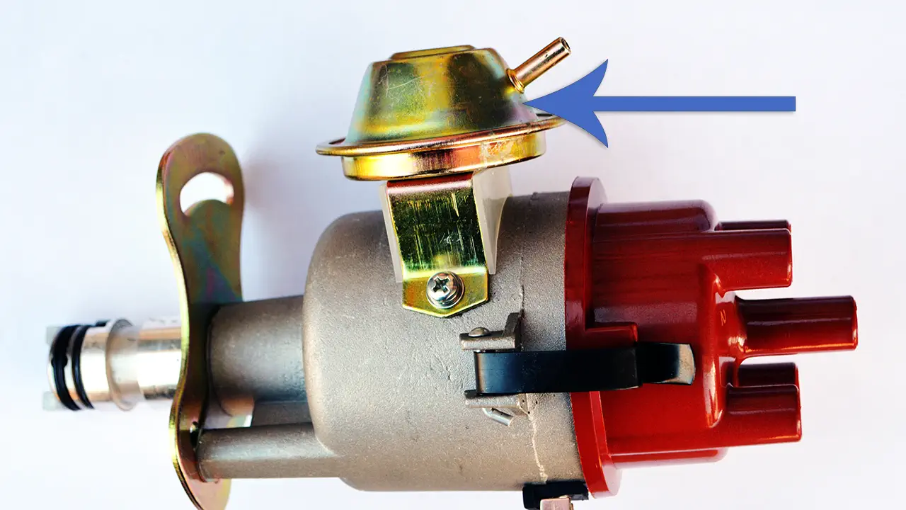 A vacuum advance unit on the side of a distributor.