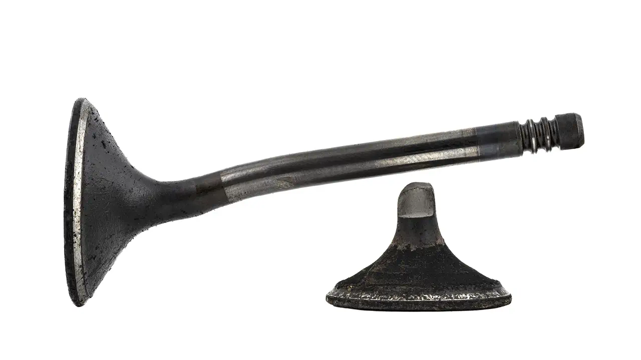 A bent and a broken valve from a car's engine.