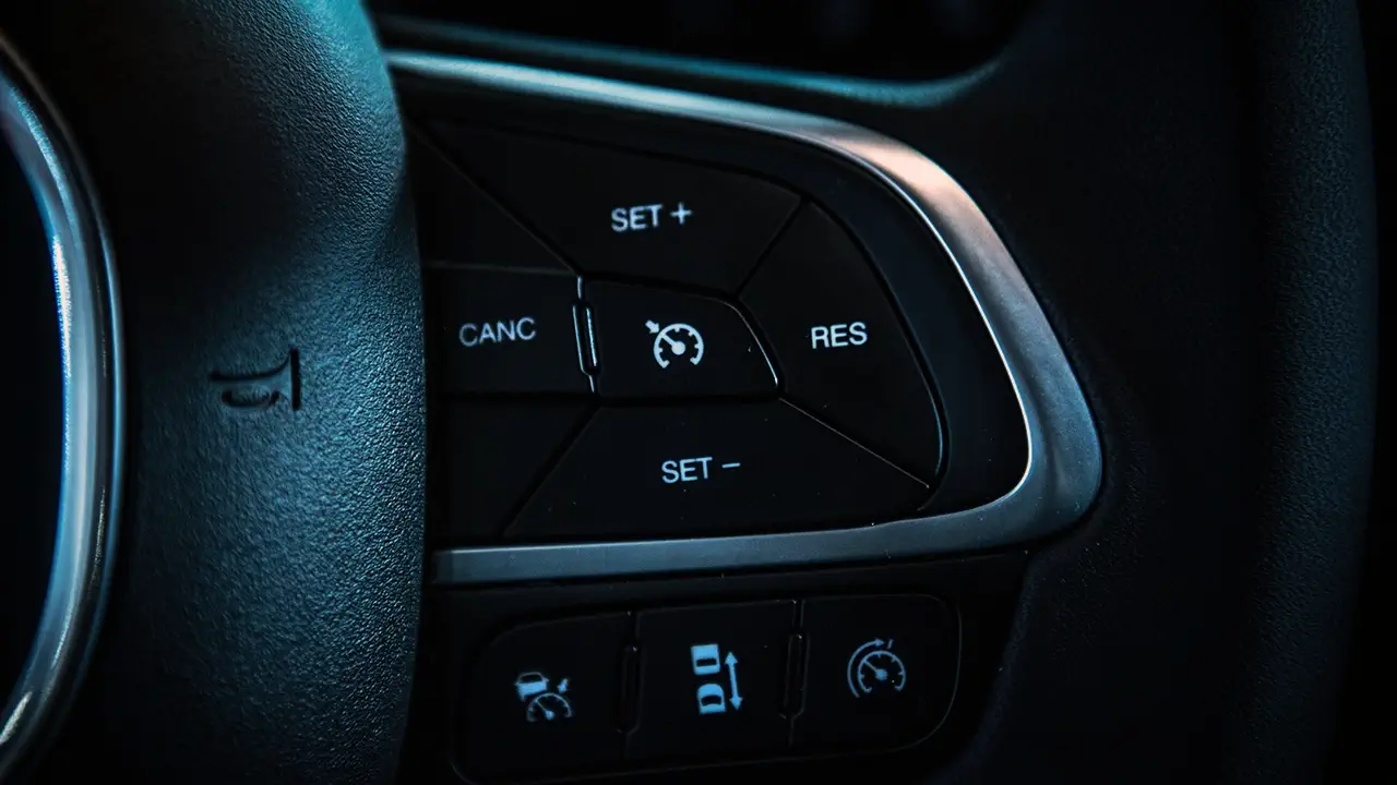 Controls on a car's steering wheel to adjust or engage cruise control.