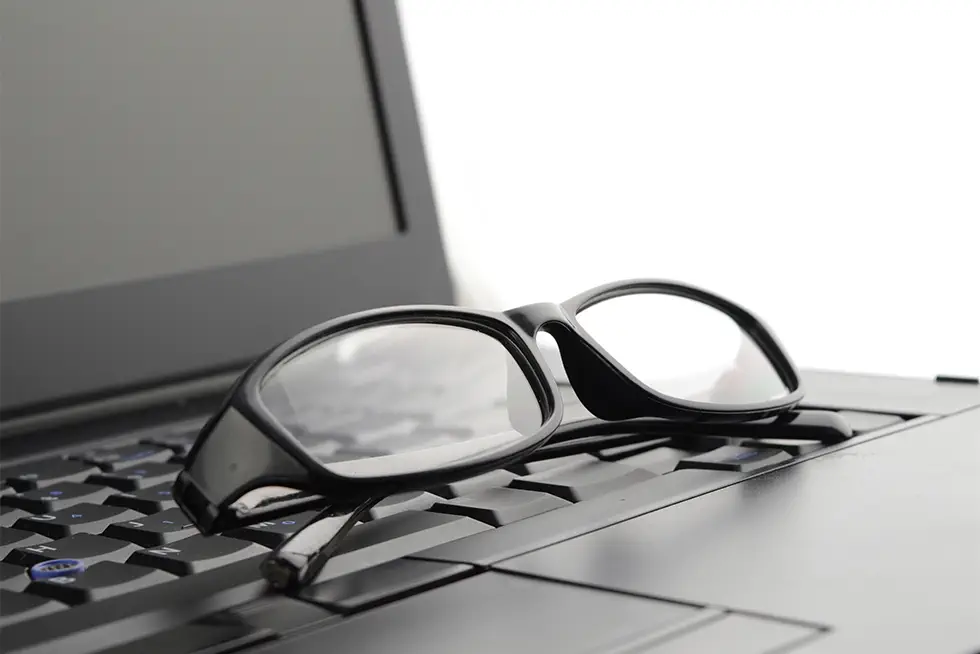 Reading Glasses on Top of Laptop Keyboard